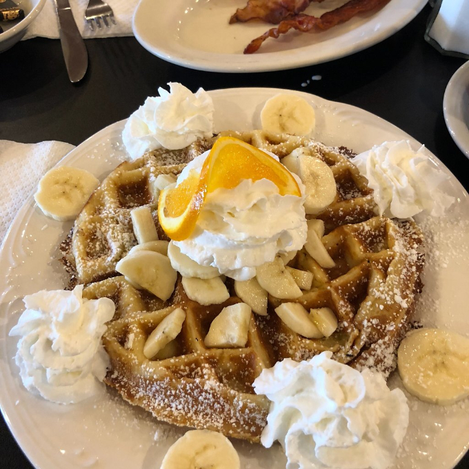 waffle with bananas and whipped cream